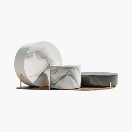 Decorative marble and ceramic display stands arranged on a copper tray in a modern still life.