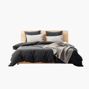 Bed Dressed in a Dark Gray Duvet with Light Gray Pillows and a Beige Throw on a Light Wood Headboard